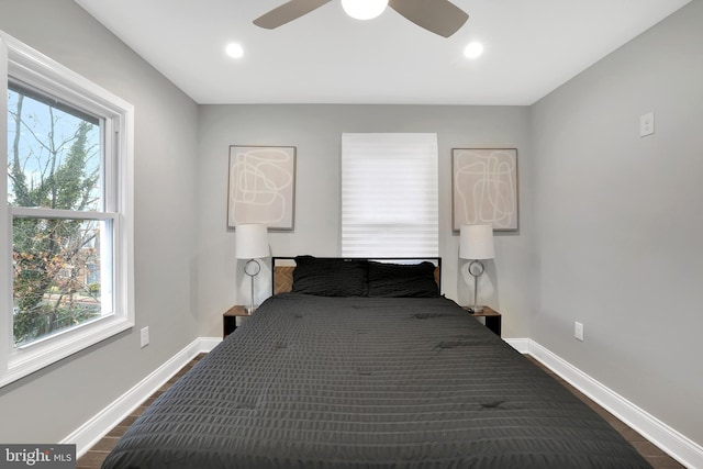 bedroom with a ceiling fan, recessed lighting, dark wood-style floors, and baseboards