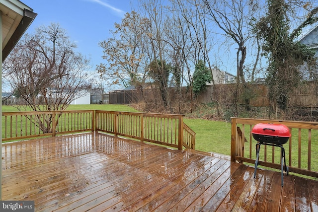 wooden terrace with a yard, a fenced backyard, and a grill