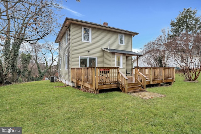 rear view of house featuring cooling unit, a yard, a wooden deck, and a chimney