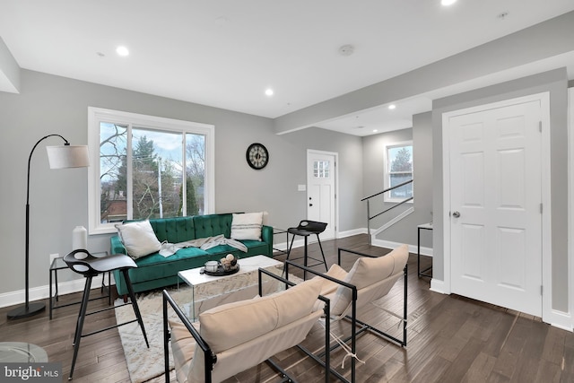 living area with recessed lighting, baseboards, and dark wood-type flooring