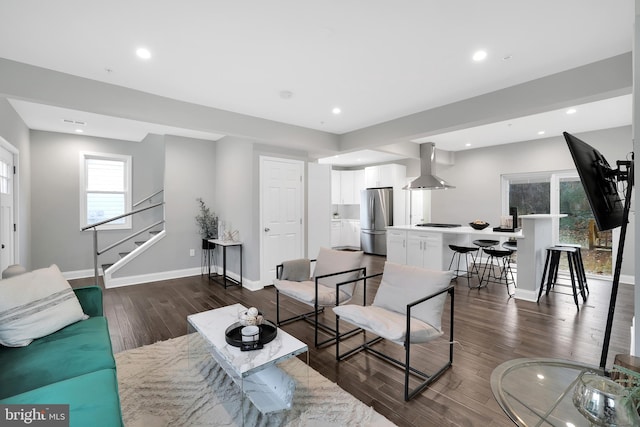 living room featuring dark wood finished floors, recessed lighting, stairs, and baseboards