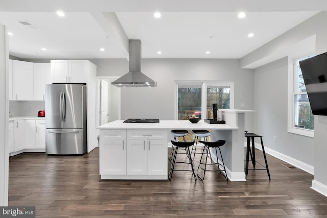 kitchen with recessed lighting, range hood, freestanding refrigerator, white cabinets, and dark wood-style flooring