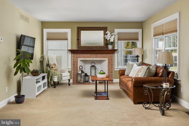 carpeted living area featuring visible vents, a fireplace, and baseboards