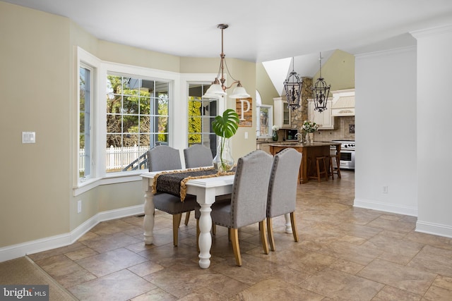 dining area with stone finish flooring and baseboards