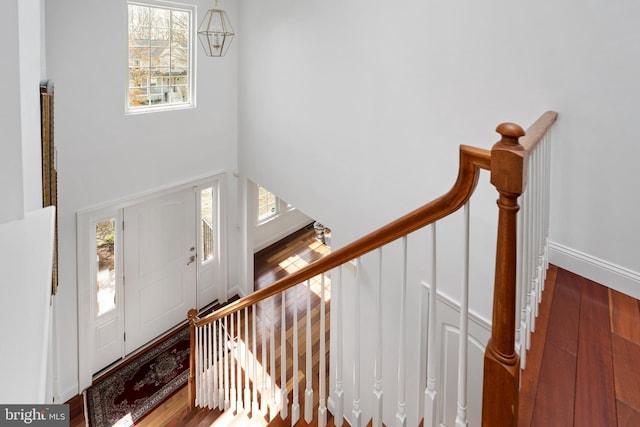 entryway with an inviting chandelier and hardwood / wood-style flooring