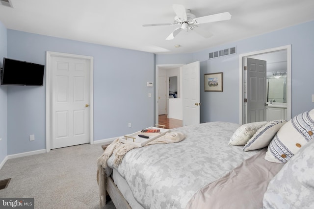 bedroom with visible vents, ceiling fan, baseboards, carpet, and ensuite bathroom