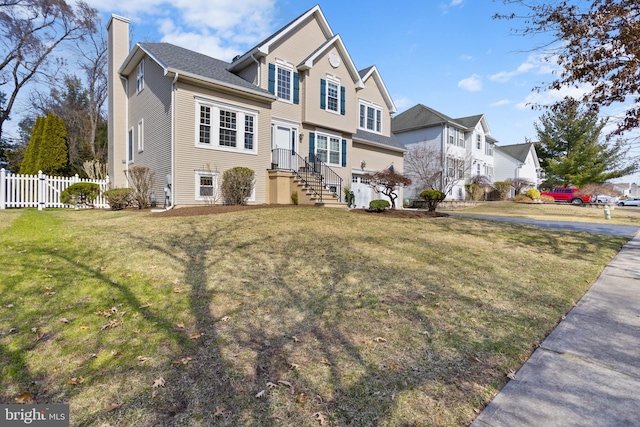 view of front of house featuring a front yard, fence, a residential view, and a chimney