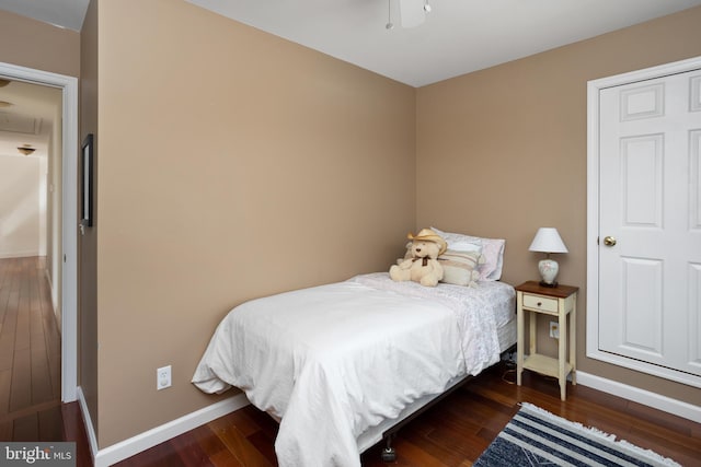 bedroom featuring baseboards and wood finished floors