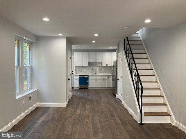 interior space featuring recessed lighting, baseboards, and wood finished floors