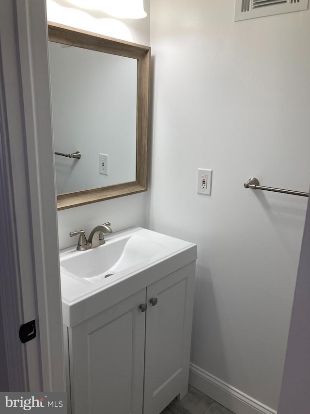 bathroom with visible vents, vanity, and baseboards