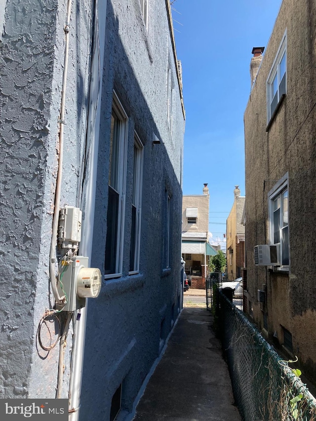 view of property exterior with stucco siding and cooling unit