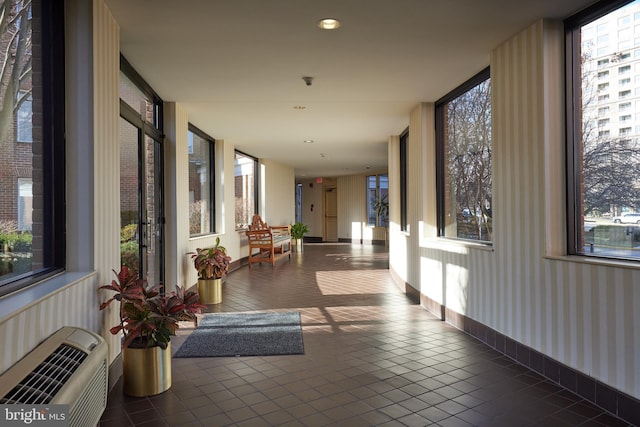 corridor with wallpapered walls, heating unit, recessed lighting, tile patterned flooring, and baseboards