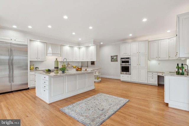 kitchen with white cabinetry, recessed lighting, light wood-style floors, and appliances with stainless steel finishes