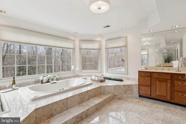 full bathroom with a bath, visible vents, and vanity