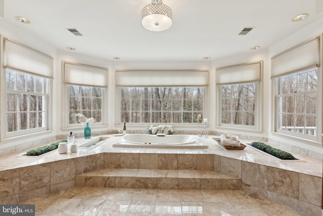 full bathroom featuring visible vents and a garden tub