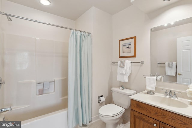 full bathroom with tile patterned floors, shower / bath combo with shower curtain, toilet, and vanity