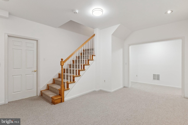 stairway featuring visible vents, baseboards, and carpet floors