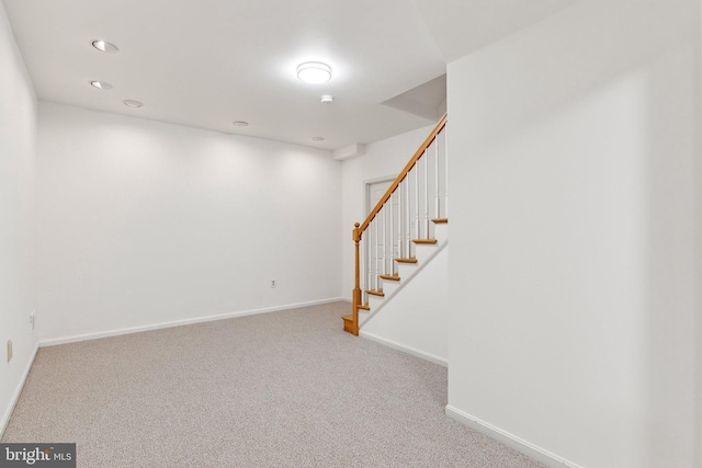 interior space featuring stairway, baseboards, and carpet floors