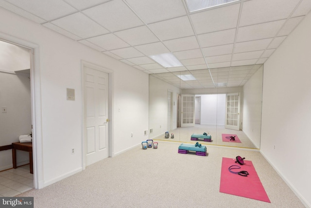 workout area with carpet flooring, visible vents, baseboards, and a drop ceiling