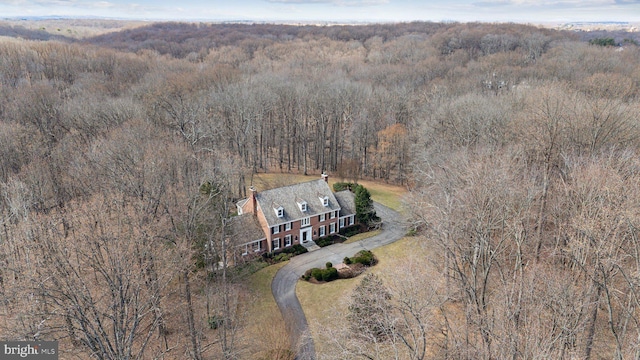 birds eye view of property featuring a view of trees