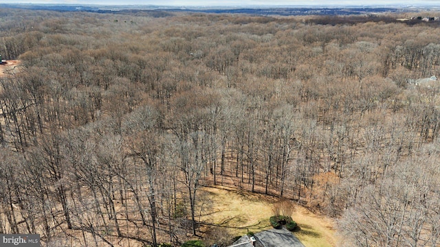 birds eye view of property with a view of trees