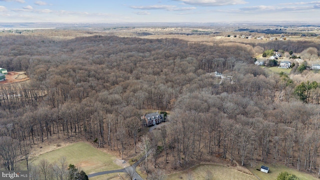 birds eye view of property with a forest view