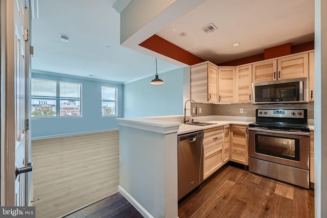 kitchen with visible vents, light brown cabinetry, a sink, stainless steel appliances, and decorative backsplash