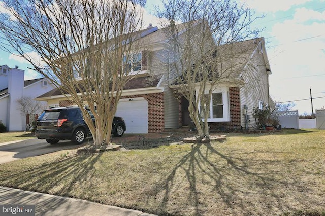 view of front facade with brick siding, driveway, an attached garage, and a front yard