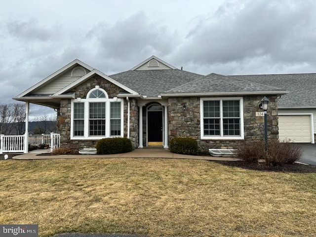 ranch-style house with a garage, a porch, a shingled roof, and a front lawn