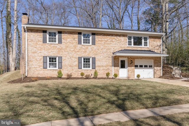 view of front of house featuring a front lawn, an attached garage, brick siding, and a chimney