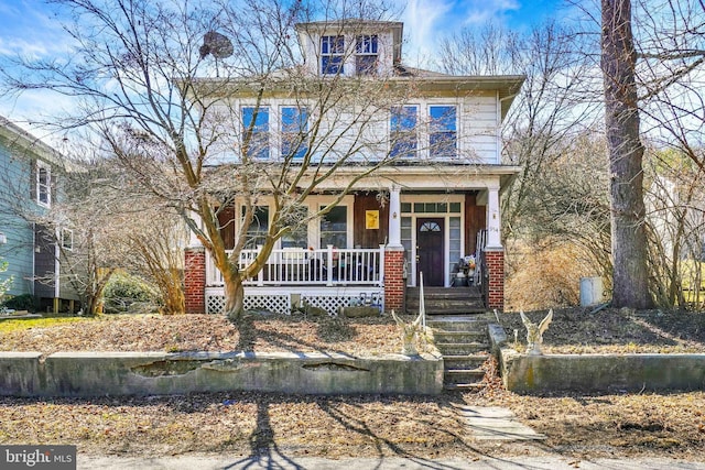 american foursquare style home with a porch