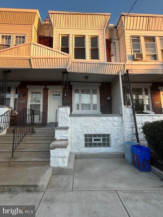 townhome / multi-family property with covered porch