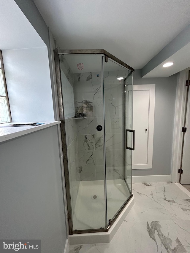 2869 Aramingo Ave, Philadelphia, PA 19134 - bathroom with baseboards, marble finish floor, and a marble finish shower