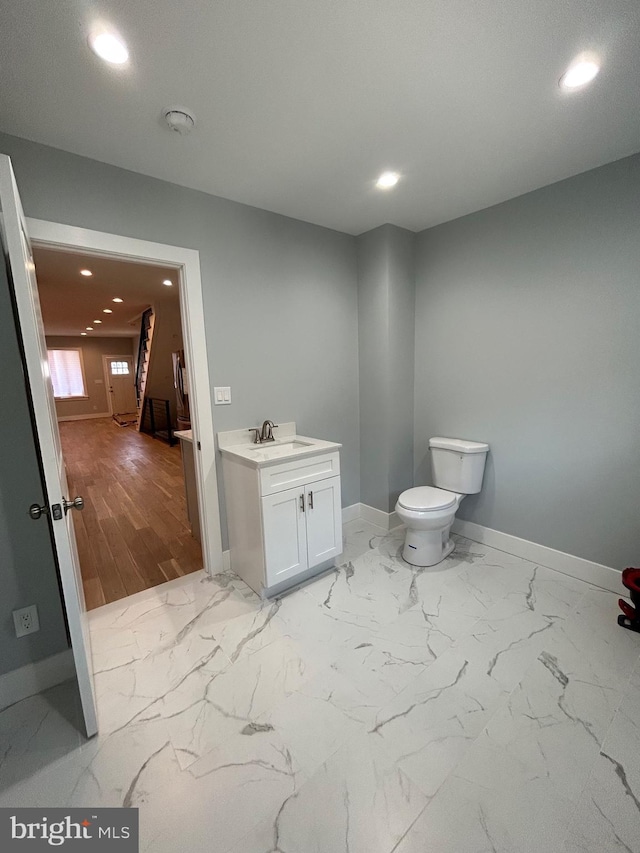2869 Aramingo Ave, Philadelphia, PA 19134 - bathroom with recessed lighting, baseboards, toilet, and marble finish floor