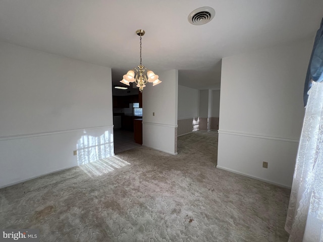unfurnished dining area featuring a chandelier, carpet flooring, and visible vents