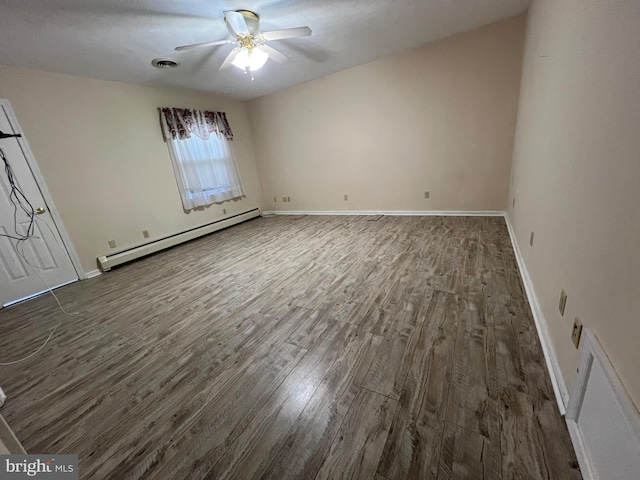 unfurnished bedroom with ceiling fan, visible vents, wood finished floors, a baseboard heating unit, and baseboards