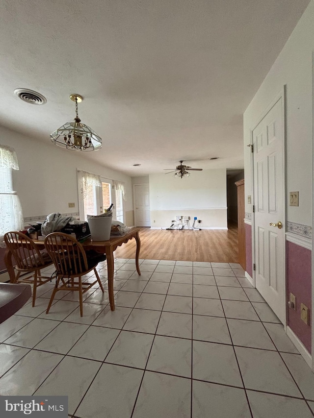 dining space featuring light tile patterned floors and visible vents