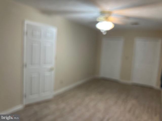 unfurnished bedroom with baseboards and light colored carpet