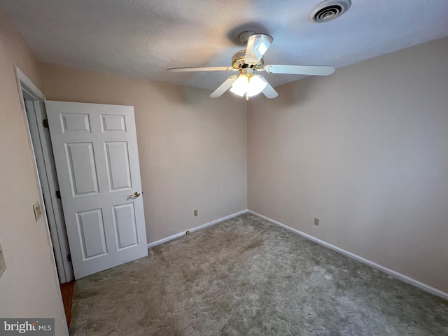unfurnished bedroom featuring carpet flooring, visible vents, baseboards, and ceiling fan