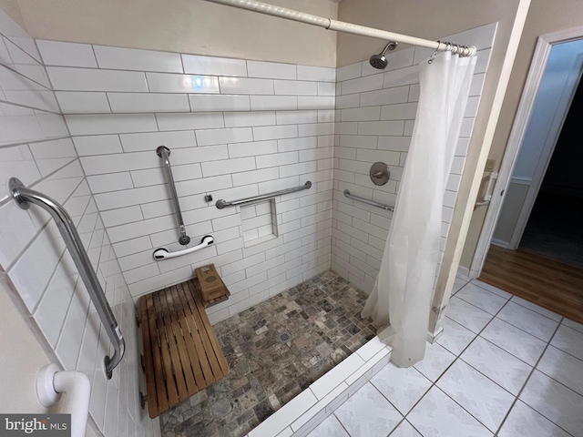 bathroom featuring a shower stall and tile patterned flooring
