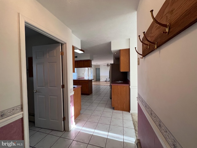 hall featuring light tile patterned flooring