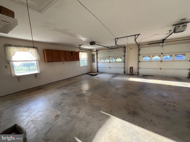 garage with electric panel and a garage door opener