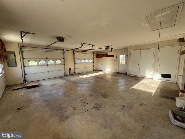 garage featuring a garage door opener and electric panel