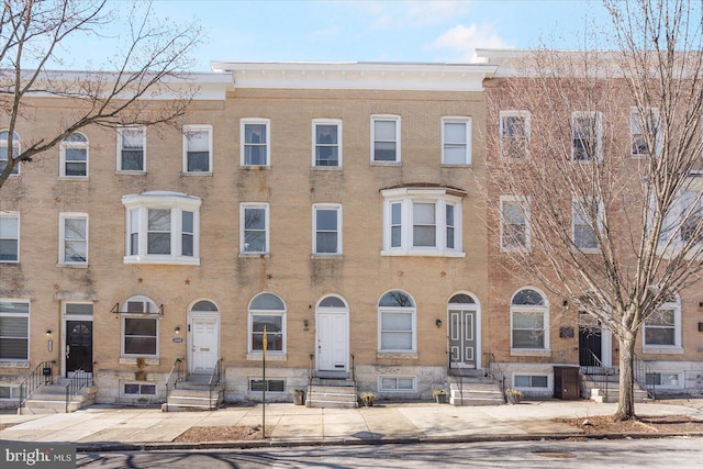 townhome / multi-family property featuring brick siding and entry steps