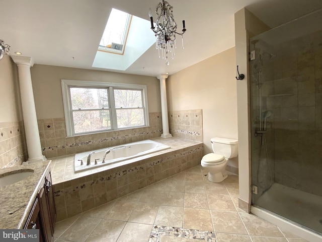 bathroom with a garden tub, toilet, a stall shower, and ornate columns