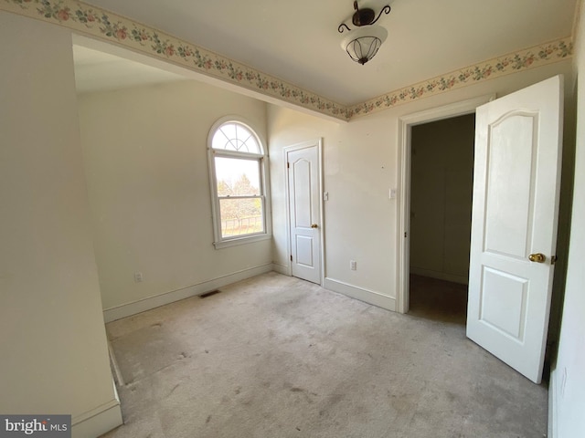 unfurnished bedroom featuring visible vents, carpet flooring, and baseboards