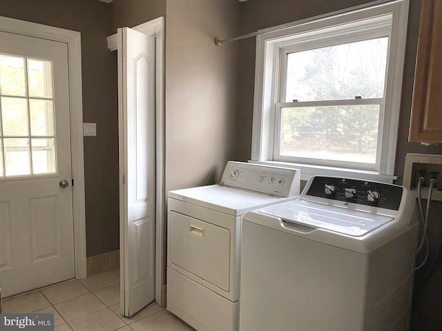 clothes washing area featuring light tile patterned floors, laundry area, and independent washer and dryer