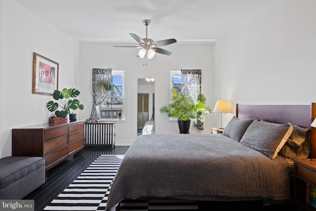 bedroom with baseboards, radiator heating unit, and ceiling fan