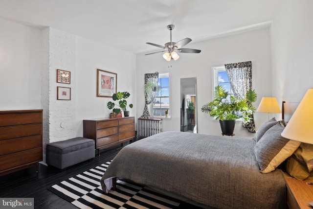 bedroom with a ceiling fan and wood finished floors