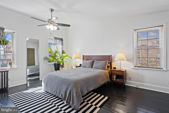 bedroom with baseboards and hardwood / wood-style flooring